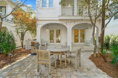 a table and chairs in front of a house at Sand On Tap in Inlet Beach