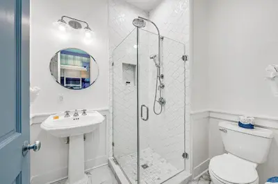 a bathroom with a shower and a toilet and a sink at Shell Of A View Cottage And Carriage House in Rosemary Beach