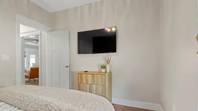 a bedroom with a flat screen tv on the wall at Pinetree Paradise! in Panama City Beach