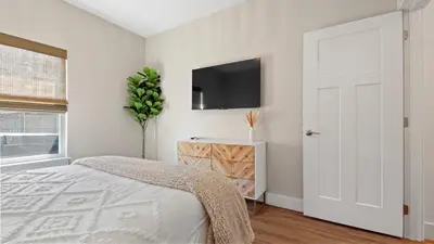 a bedroom with a bed and a tv on the wall at Pinetree Paradise! in Panama City Beach