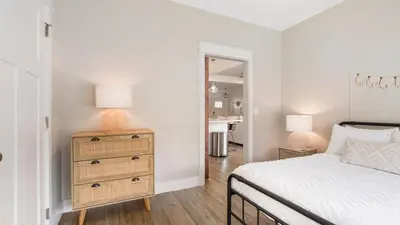 a bedroom with a bed and a dresser with a lamp at Pinetree Paradise! in Panama City Beach