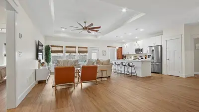 a kitchen and living room with a ceiling fan at Pinetree Paradise! in Panama City Beach
