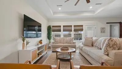 a living room with a couch and a table at Pinetree Paradise! in Panama City Beach