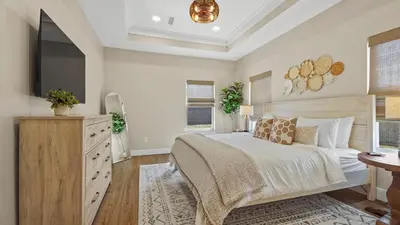 a bedroom with a large bed and a television at Pinetree Paradise! in Panama City Beach
