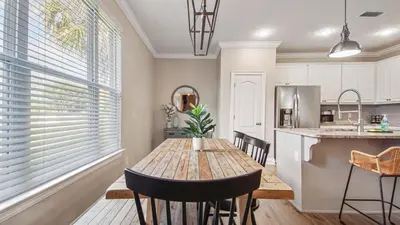 a kitchen and dining room with a wooden table at Guilty Treasure in Panama City Beach