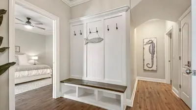a room with a hallway with a bed and a stairway at Guilty Treasure in Panama City Beach