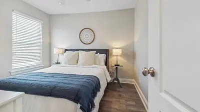 a bedroom with a large bed with a blue blanket at Guilty Treasure in Panama City Beach