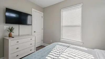 a bedroom with a bed and a flat screen tv at Guilty Treasure in Panama City Beach