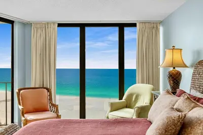 a bedroom with a view of the ocean at 2BD Edgewater Beach & Golf Resort! Best Amenities! by Dolce Vita Getaways PCB in Panama City Beach