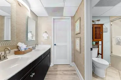 a bathroom with two sinks and a toilet at 2BD Edgewater Beach & Golf Resort! Best Amenities! by Dolce Vita Getaways PCB in Panama City Beach