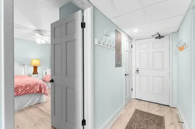 a bedroom with a white door and a bed at 2BD Edgewater Beach & Golf Resort! Best Amenities! by Dolce Vita Getaways PCB in Panama City Beach