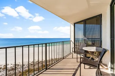 a balcony with a table and chairs and the ocean at 2BD Edgewater Beach & Golf Resort! Best Amenities! by Dolce Vita Getaways PCB in Panama City Beach
