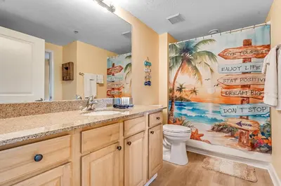 a bathroom with a sink and a toilet at Beachfront 3BR Condo! Free Beach Chair Service! by Dolce Vita Getaways PCB! in Panama City Beach