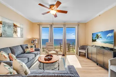 a living room with a couch and a ceiling fan at Beachfront 3BR Condo! Free Beach Chair Service! by Dolce Vita Getaways PCB! in Panama City Beach