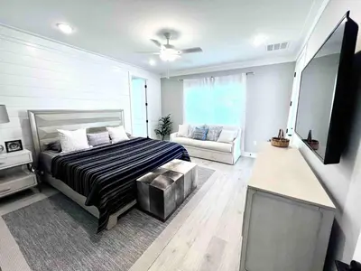 a bedroom with a bed and a couch in it at R3 at Lake Powell near Panama City Beach and 30A in Panama City Beach