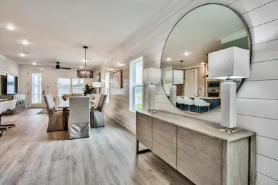 a dining room and living room with a mirror at R3 at Lake Powell near Panama City Beach and 30A in Panama City Beach