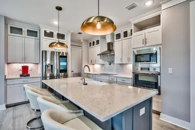 a large kitchen with white cabinets and a large island at R3 at Lake Powell near Panama City Beach and 30A in Panama City Beach