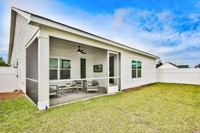 a white house with a patio and a fence at R3 at Lake Powell near Panama City Beach and 30A in Panama City Beach