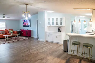 an open living room with a kitchen and a living room at R3 Orange at Inlet Beach with Pool, EV Connector and RV Parking in Inlet Beach