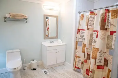 a bathroom with a toilet and a shower curtain at R3 Orange at Inlet Beach with Pool, EV Connector and RV Parking in Inlet Beach