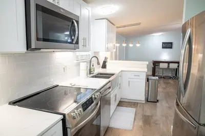 a kitchen with a sink and a stove top oven at R3 Orange at Inlet Beach with Pool, EV Connector and RV Parking in Inlet Beach