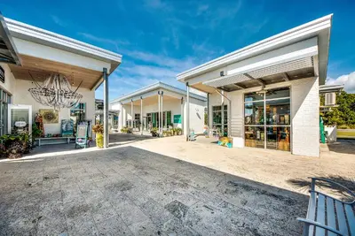 a large building with a lot of windows at Whale Tales Prominence 30A! BESIDE POOL! 6 seater LSV! 4 Bikes Sleeps 6! in Watersound Beach