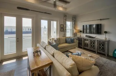 a living room with a couch and a tv at Whale Tales Prominence 30A! BESIDE POOL! 6 seater LSV! 4 Bikes Sleeps 6! in Watersound Beach