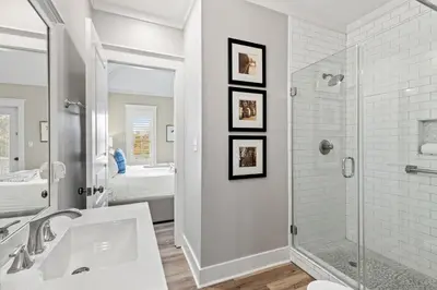 a white bathroom with a shower and a sink at Laid Back in Inlet Beach