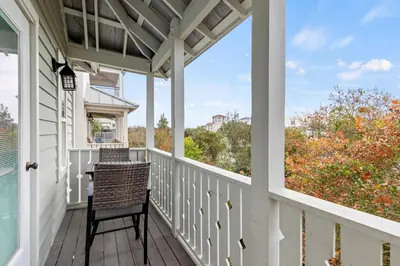 a porch with a chair and a view at Laid Back in Inlet Beach