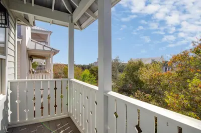 a white porch with a view of trees at Laid Back in Inlet Beach