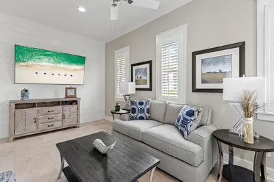 a living room with a couch and a table at Laid Back in Inlet Beach