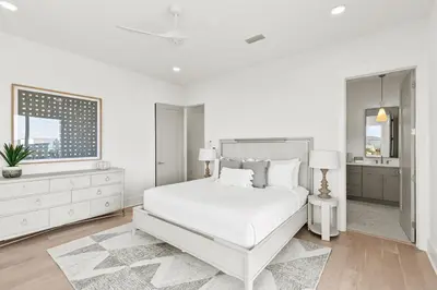 a white bedroom with a white bed and a window at The Luxe Lookout in Inlet Beach