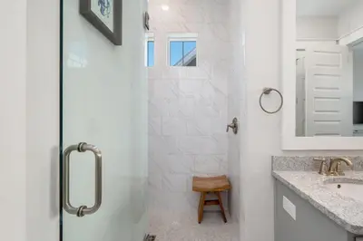 a white bathroom with a shower and a sink at Sea - Esta Prominence 30A! BESIDE POOL! 6 seater LSV! 4 Bikes Sleeps 6! in Watersound Beach