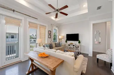 a living room with a couch and a table at Sea - Esta Prominence 30A! BESIDE POOL! 6 seater LSV! 4 Bikes Sleeps 6! in Watersound Beach