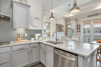 a kitchen with white cabinets and a sink at Sea - Esta Prominence 30A! BESIDE POOL! 6 seater LSV! 4 Bikes Sleeps 6! in Watersound Beach