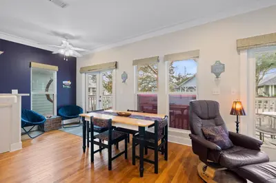 a dining room with a table and chairs at Peacock Cottage in Inlet Beach