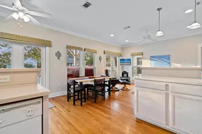 a kitchen and dining room with a table and chairs at Peacock Cottage in Inlet Beach