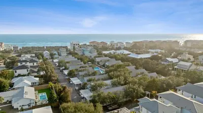 an aerial view of a city with houses and the ocean at Peacock Cottage in Inlet Beach