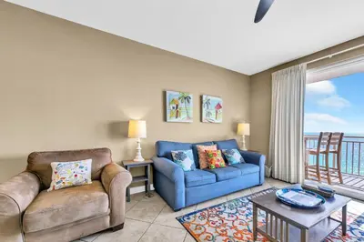 a living room with a couch and a table at Sterling Reef 1404 in Panama City Beach