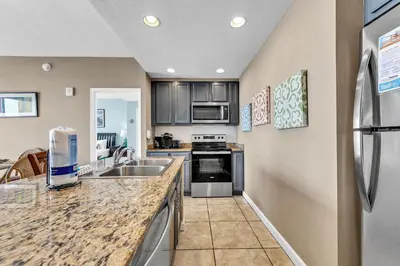 a kitchen with a sink and a counter top at Sterling Reef 1404 in Panama City Beach