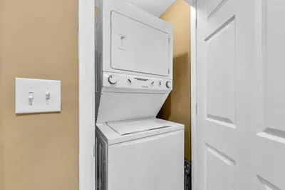 a white washer and dryer in a room at Sterling Reef 1404 in Panama City Beach
