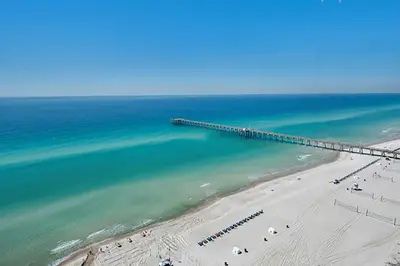 an aerial view of a beach with a pier at Calypso 2-2108 West in Panama City Beach