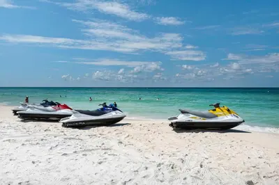 four speedboats are lined up on a beach at Calypso 2-2108 West in Panama City Beach