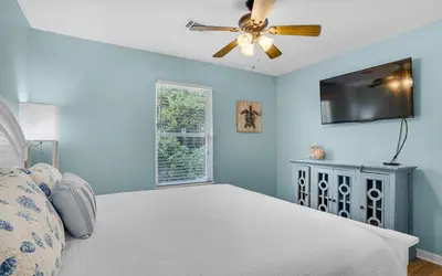 a bedroom with a bed and a ceiling fan at Sand Dollar B by Emerald Coast Retreats in Panama City Beach