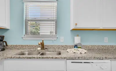 a kitchen counter with a sink and a window at Sand Dollar A by Emerald Coast Retreats in Panama City Beach