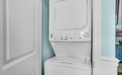 a white washer and dryer in a room at Sand Dollar A by Emerald Coast Retreats in Panama City Beach