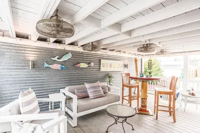 a living room with a couch and a table at A Wave From It All in Laguna Beach Large Patio Sleeps 4 Dog Ok in Panama City Beach