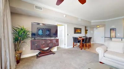 a living room with a tv and a couch at Tidewater 0509 in Panama City Beach