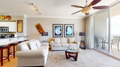 a living room with a couch and a table at Tidewater 0509 in Panama City Beach