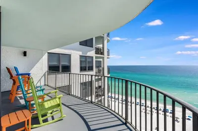 a balcony of a house with chairs and the ocean at Watercrest 1510 - Timeless Memories Stunning views in Panama City Beach